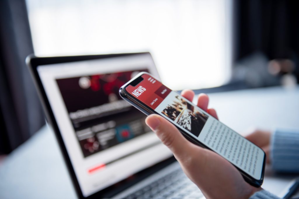 Person reading news on mobile phone