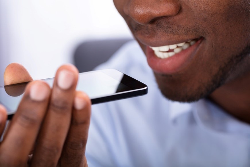 Man speaking into phone to use voice search