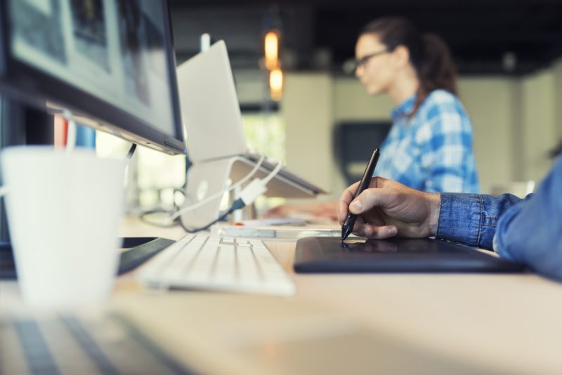 Man Working on graphic tablet in modern startup