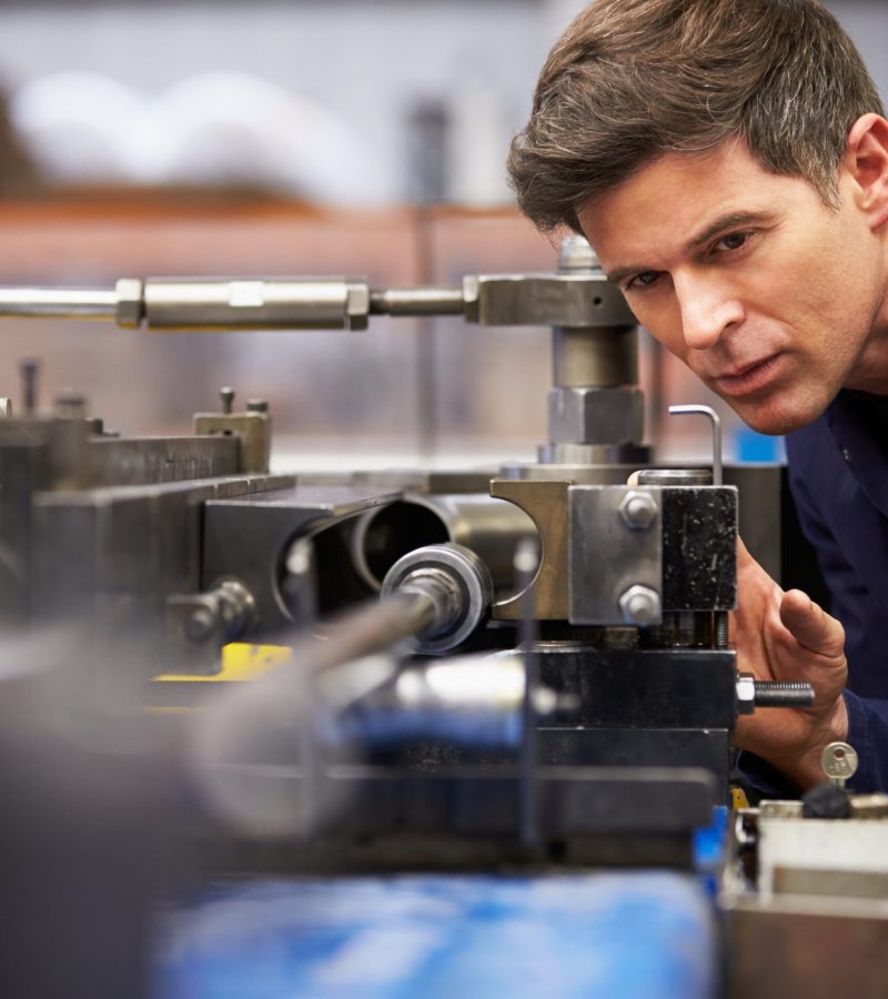 Close Up Of Factory Engineer Operating Hydraulic Tube Bender